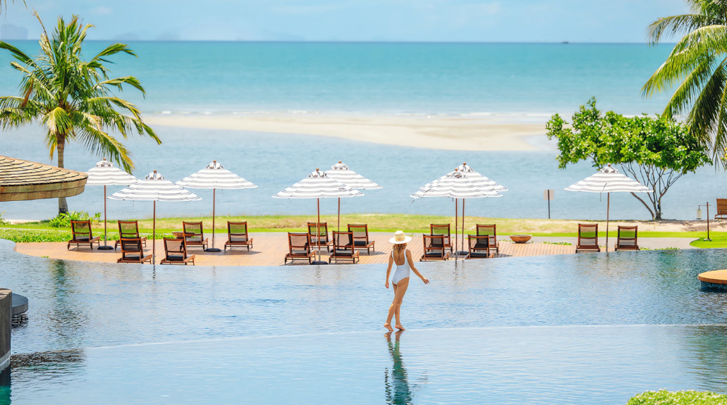 Woman walking through infinity pool at Anantara Koh Yao Yai Resort & Villas - Luxury Escapes