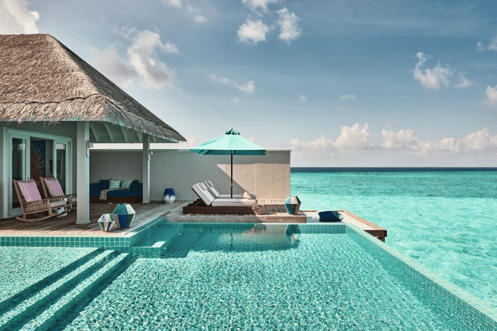 A view of the private pool, thatched roof, sun beds and sweeping ocean outlook at the Rockstar Villa, one of the most unique parts of Seaside Finolhu Baa Atoll - Luxury Escapes