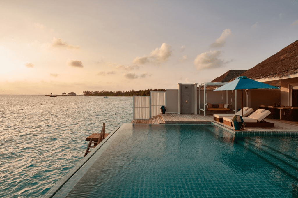 The private pool, decking and sunbeds of Seaside Finolhu Baa Atoll's Two Bedroom Water Villa, one of the most luxurious villas in the Maldives - Luxury Escapes