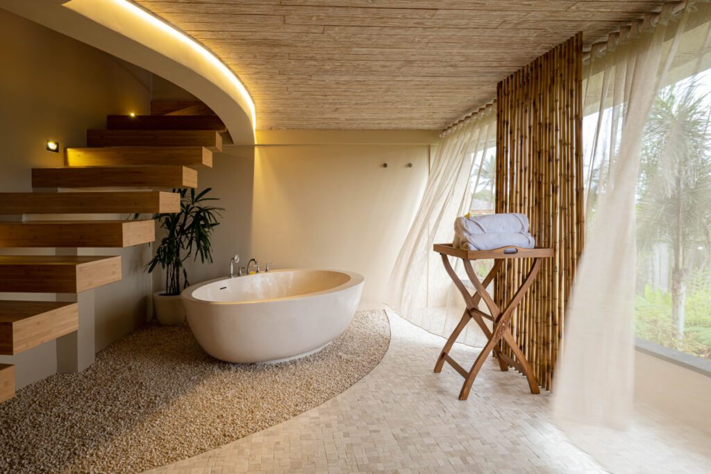 A treatment room and bathtub at OmTara Spa by Clarins at Kappa Senses Ubud, one of the most blissful retreats in Bali - Luxury Escapes