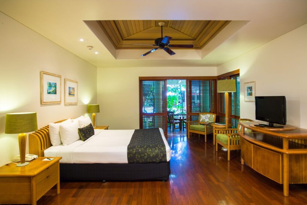 The interiors of the Island Suite Room at Green Island Resort boasts soaring ceilings, natural wood textures, air-conditioning, separate bathtubs and fuss-free, sea-breezy decor - Luxury Escapes