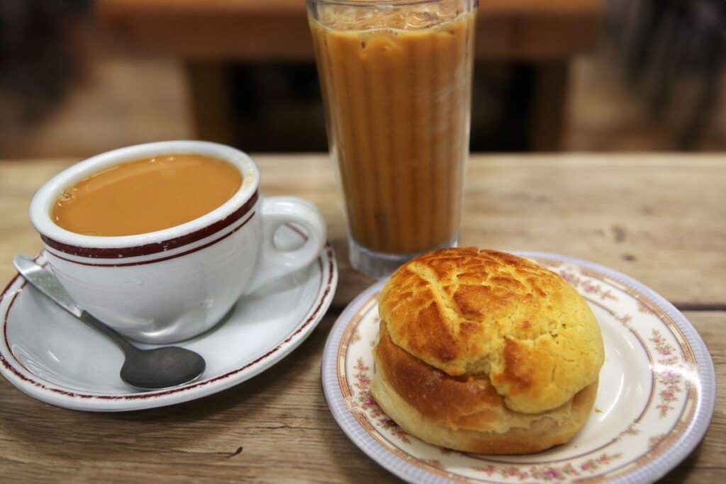 A classic Hong Kong breakfast with pineapple bun and milk tea - Luxury Escapes