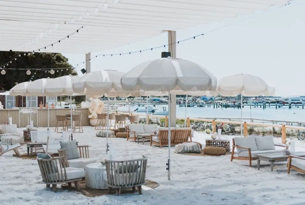 Beachside lounging with white umbrellas and coastal decor at Dream by Luxury Escapes.