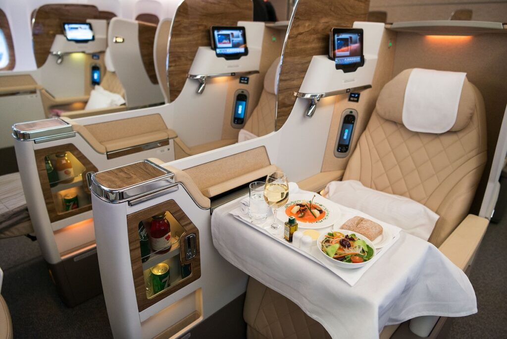 Dinner in the Emirates flight B777-300ER business class cabin - Luxury Escapes