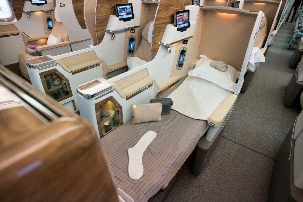 View of the Emirates flight B777-300ER business class cabin bed - Luxury Escapes