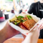 Street food being handed to customer - Luxury Escapes