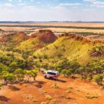 A Red Dirt Tours bus in Outback Queensland, one of the best things to do in Outback Queensland