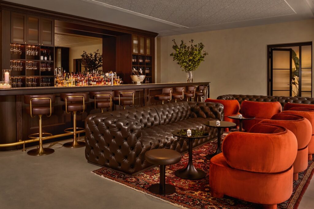 A large bar and leather Chesterfields at the new 25Hours Hotel Sydney The Olympia - Luxury Escapes