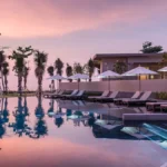 Sunset over a pool at The Little Shore at Khao Lak - Luxury Escapes