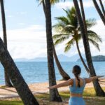 Beachfront yoga at The Reef House Palm Cove, one of Australai's best wellness retreats - Luxury Escapes