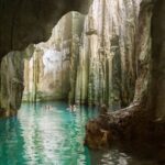 Family swimming in a cave on a Fiji holiday - Luxury Escapes