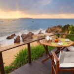 A table set for two overlooking the beach at Avani Quy Nhon Resort