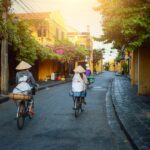 Women cycling through the streets of Vietnam