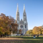 Sigmund Freud Park with a view of the Votive Church in autumn, to illustrate when to go to Vienna - Luxury Escapes