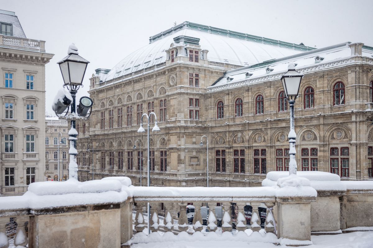 Vienna State Opera in the snow in winter, to illustrate when to go to Vienna - Luxury Escapes