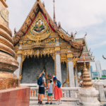 Family visiting a temple in Bangkok. Image credit: Shutterstock, avtk.