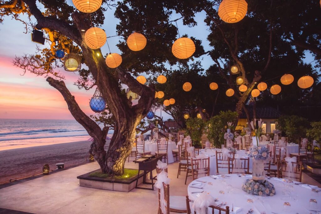 A destination wedding set-up on the beach with lanterns.