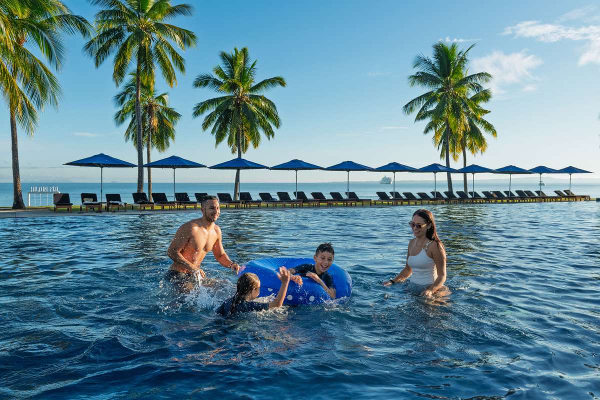 Children playing in the family pool at Hilton Fiji Beach Resort & Spa, Denarau Island - Luxury Escapes