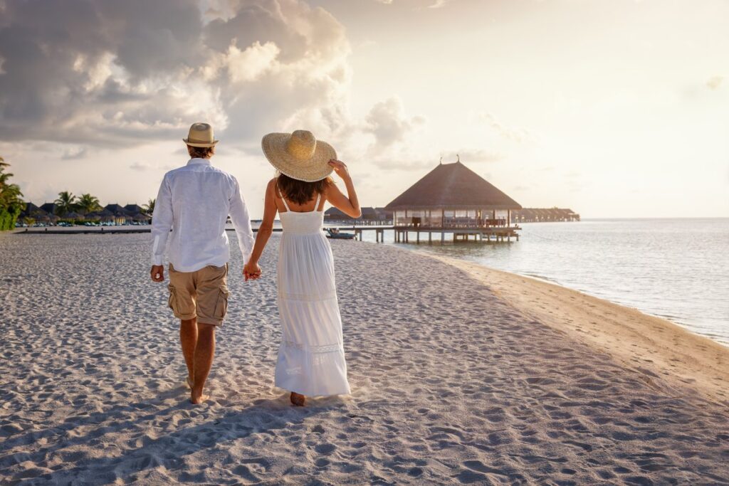 Honeymoon couple on the beach. Planning a destination wedding and honeymoon at the same time might make things easier.