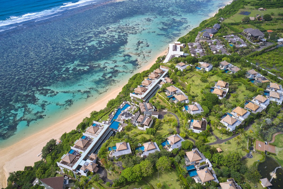 Aerial shot of cliffside resort Samabe Bali Suites & Villas. Luxury Escapes.
