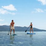 Guests stand-up paddleboarding near The Sira, Lombok.