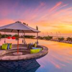 Infinity pool at Grand Mirage Resort & Thalasso Bali at sunset