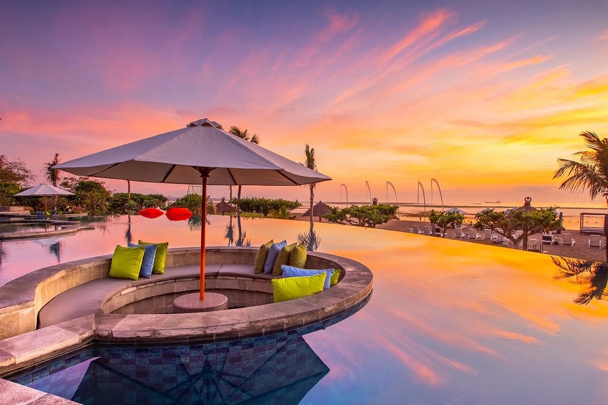 Infinity pool at Grand Mirage Resort & Thalasso Bali at sunset