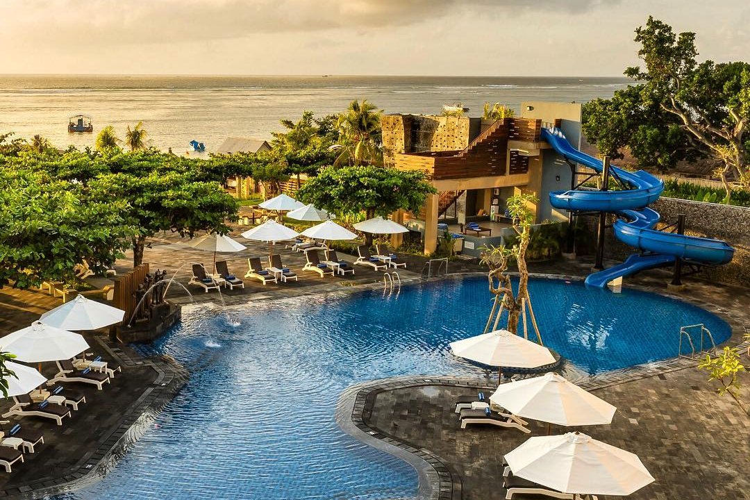 Beachfront pool with waterslides at Grand Mirage Resort & Thalasso Bali