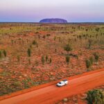 A vehicle on the red road towards Uluru, Northern Territory