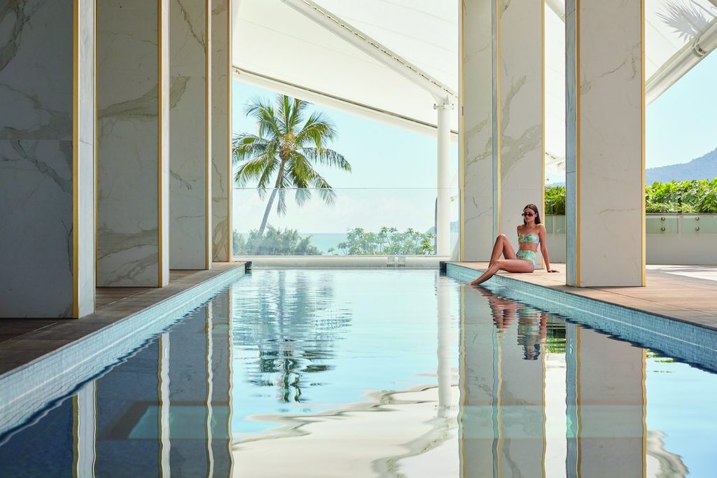 Guest beside rooftop pool at Crystalbrook Flynn, Cairns