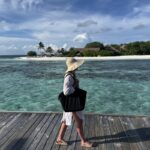 Walking along a boardwalk over the Maldives lagoon