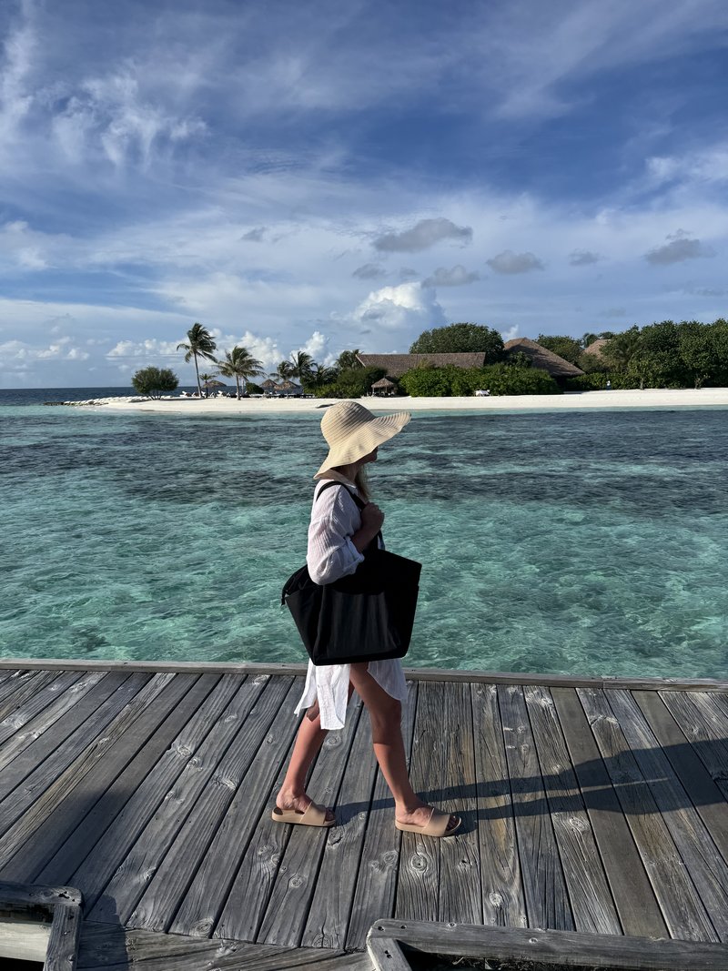Walking along a boardwalk over the Maldives lagoon