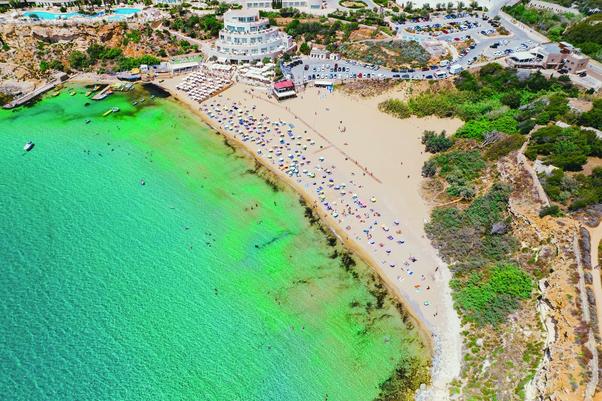 Aerial view of sandy beach and turquoise sea in Malta