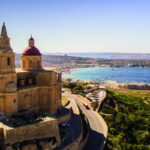 Stone church overlooking a coastal bay in Malta