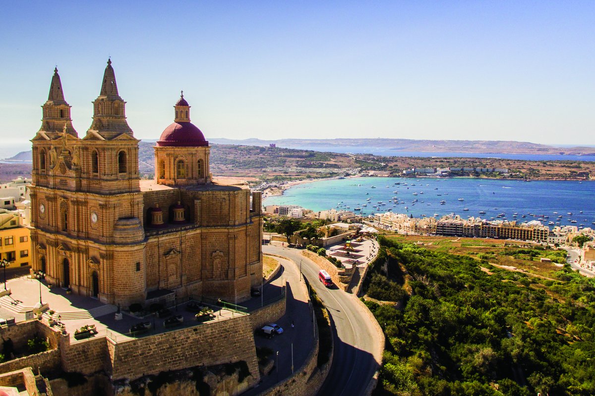 Stone church overlooking a coastal bay in Malta