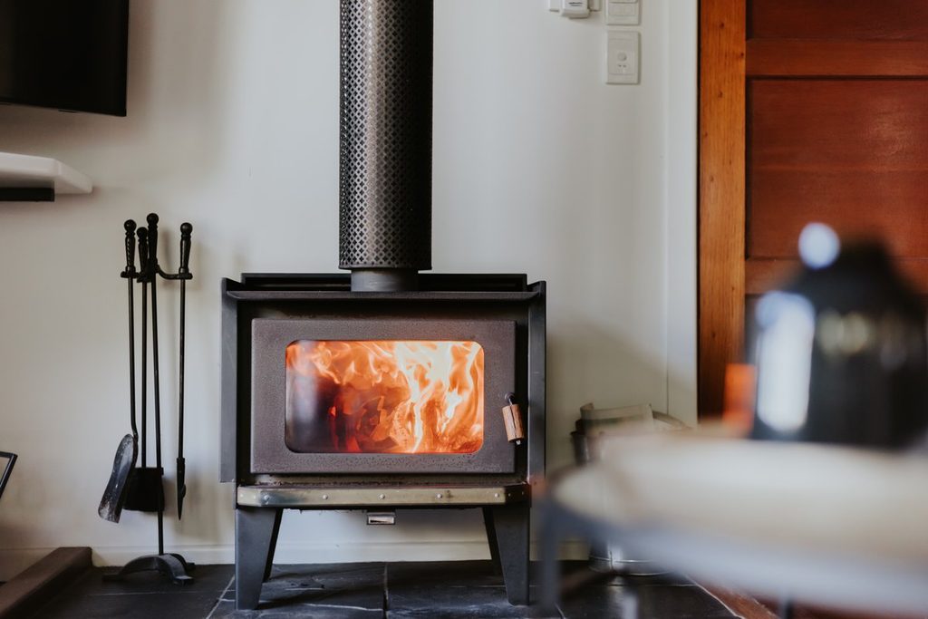 Wood-burning fireplace inside Misty View Cottages