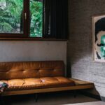 Modern lounge with leather seating, bold artwork and garden views at Ovolo Canberra | Luxury Escapes