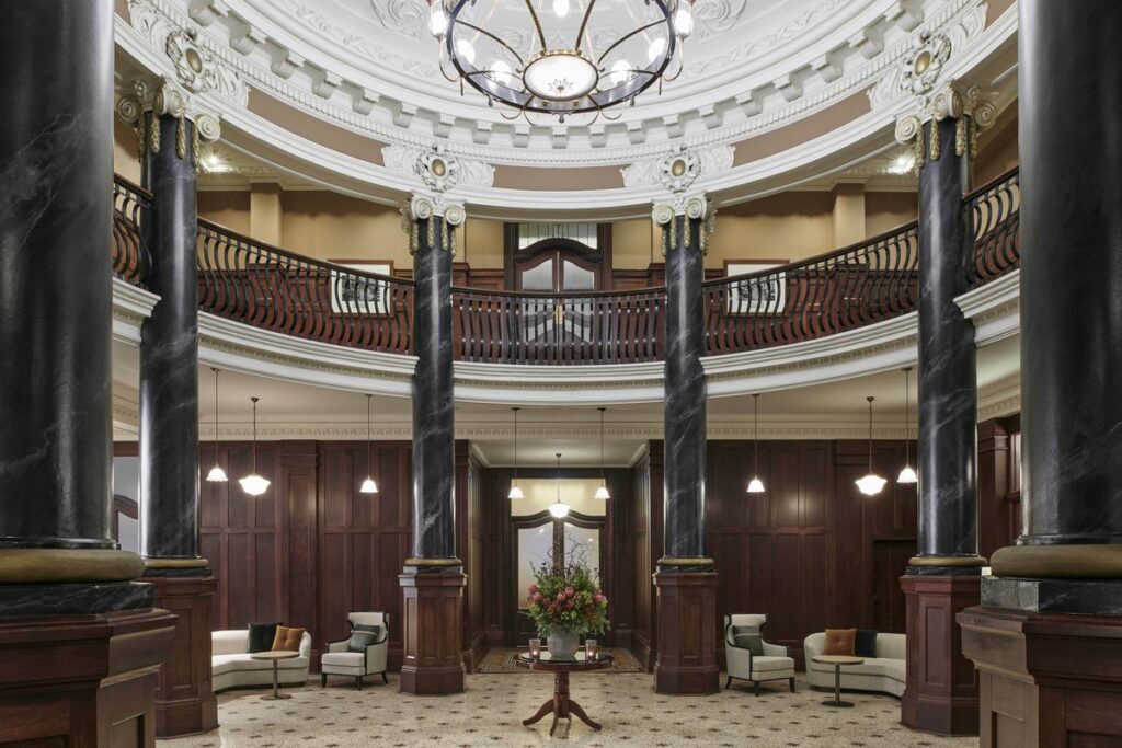 Grand heritage lobby with marble columns at Rendezvous Hotel Melbourne