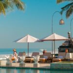 Loungers beside infinity pool at The Seminyak Beach Resort & Spa, Bali