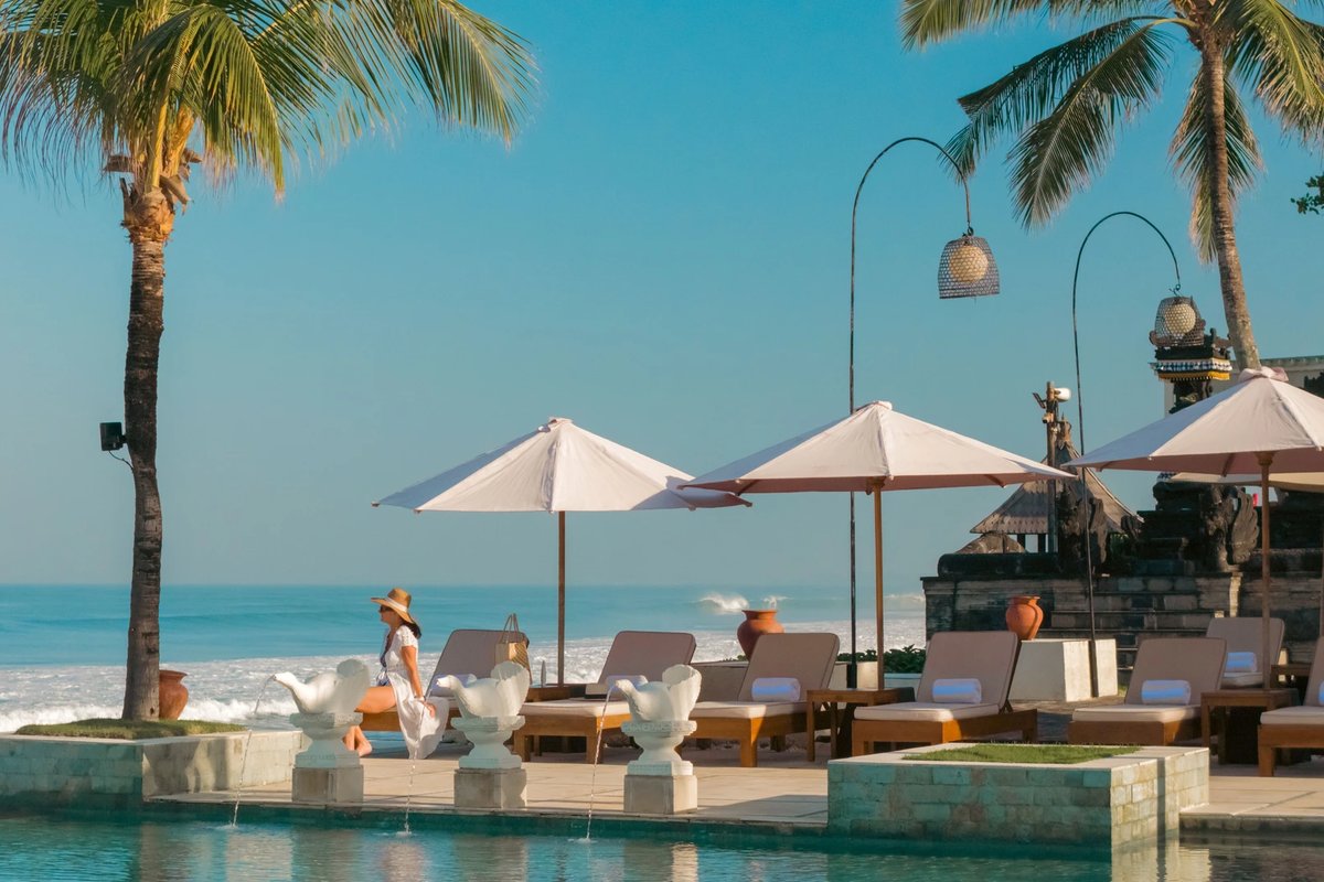 Loungers beside infinity pool at The Seminyak Beach Resort & Spa, Bali